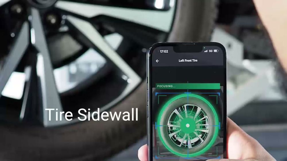 Anyline / TireBuddy, stage 3: Sidewall scan on a real phone: header 'Left Front Tire', status bar 'FOCUSING...', green r