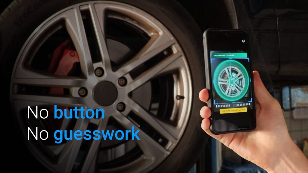 Anyline / TireBuddy, stage 4: Same clip: on-video text 'No button. No guesswork'; phone screen shows the capture ring in