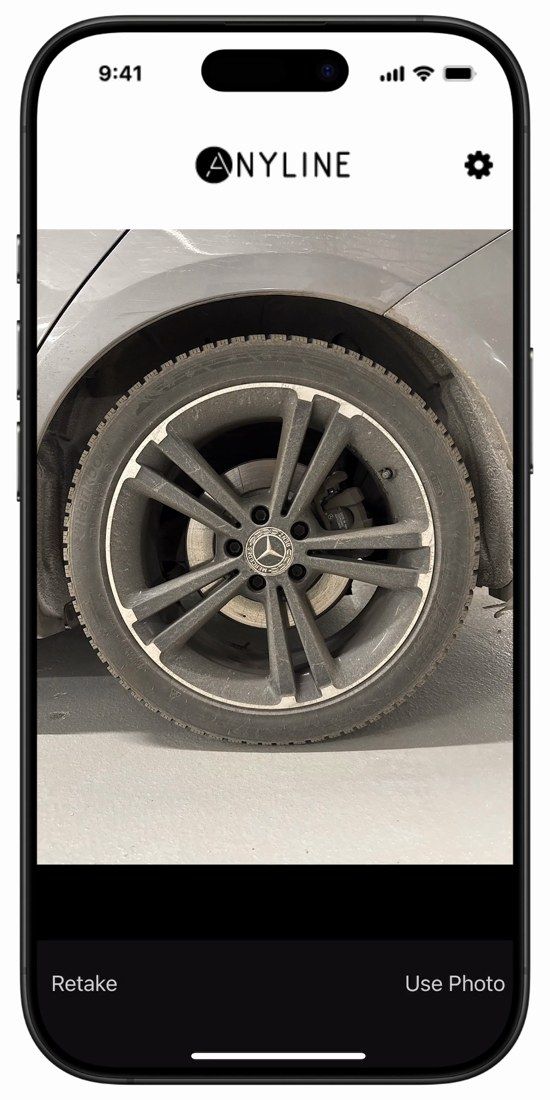 Anyline / TireBuddy, stage 5: Captured wheel photo with iOS camera confirmation bar 'Retake' / 'Use Photo' - the retake 
